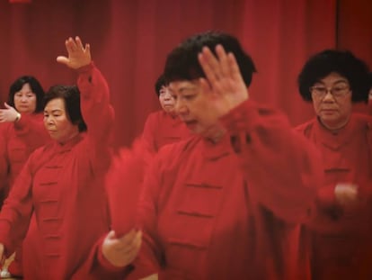 A group of Chinese seniors practices a traditional dance in the cultural center of Chinese New Year.