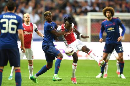 El jugador del Machester United Paul Pogba trata de arrebatarle el balón al jugador del Ajax Bertrand Traor.