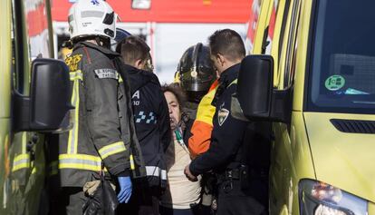 Bomberos atienden a unos heridos en un incendio.