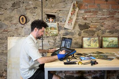 En la imagen, el gallego Julio Falagán, de 42 años, trabaja en su obra ‘Zoom out’, para la que ha digitalizado cuadros colgados en las paredes de las casas del pueblo.