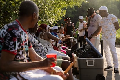 Musicians rest on benches, eating and drinking, between songs. 