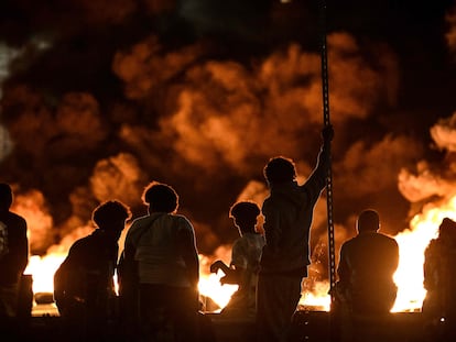 Un grupo de jóvenes junto a una barricada de neumáticos en llamas, este jueves en Burdeos.