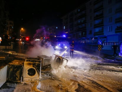 Un bombero extingue algunos de los productos quemados por manifestantes turcos durante su asalto a negocios y viviendas de refugiados sirios en el distrito de Altindag, en Ankara.