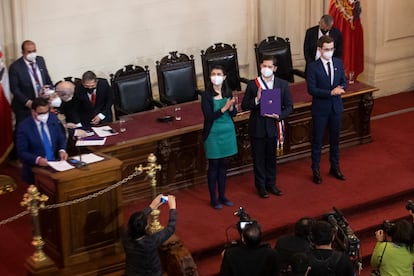 La presidenta de la Convención Constitucional, María Elisa Quinteros, y el vicepresidente, Gaspar Domínguez, aplauden mientras Gabriel Boric recibe el texto final de la propuesta de Carta Magna, el 4 de julio de 2022.