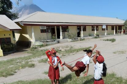 Unas ni?as juegan en el patio de su escuela cercana al Monte Sinabung que contina arrojando humo y ceniza en Karo, al norte de la isla de Sumatra (Indonesia).