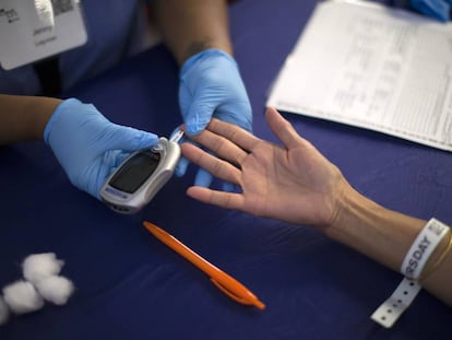 A diabetes test is administered. Up to one-third of people with diabetes can experience skin problems related to the disease. 