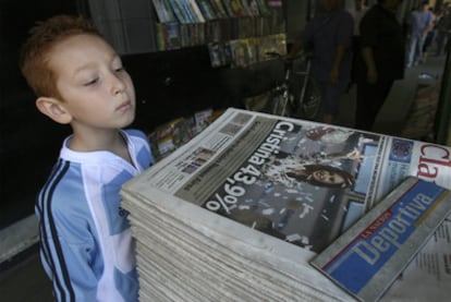 Un niño argentino observa la portada de <i>Clarín</i> tras el triunfo electoral de Cristina Kirchner en 2007.
