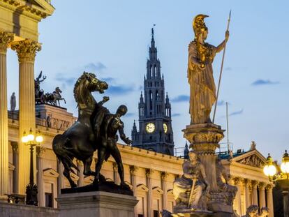 El edificio del Parlamento, con una estatua de Palas Atenea en primer plano y la torre del ayuntamiento al fondo.