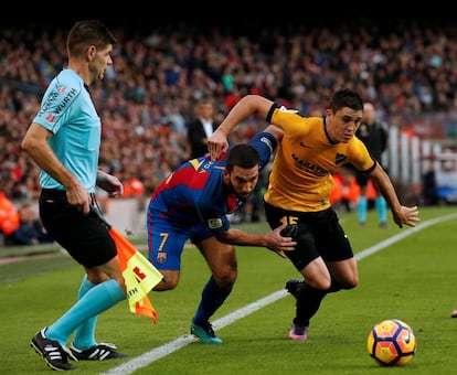 Cremi Turan (centre) del Barcelona i Federico Ricca del Màlaga, en acció.