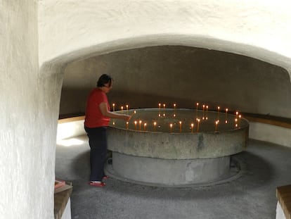 Museologist Andrea Dobes at the candlelit memorial in the former prison of Sighet, Romania.