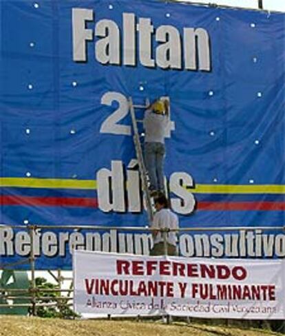 Un voluntario cambia el número de los días que quedan para la votación.