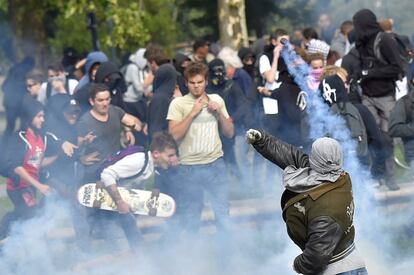 Un manifesante devuelve un bote de gas lacrimógeno a los policías antidisturbios durante las protestas en Nantes.