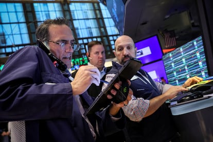 Traders work on the floor at the New York Stock Exchange on July 3, 2024.