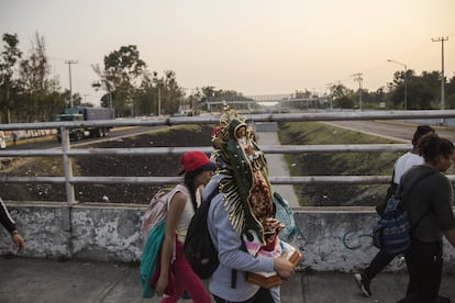 Una pareja transporta una imagen de la Virgen de Guadalupe.