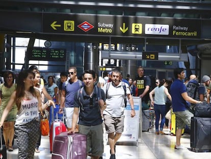 Viajeros en el pasillo de la Terminal 4 del aeropuerto de Madrid-Barajas que conecta con el Metro y la estación de Cercanías.