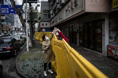 A woman collects food in the city of Wuhan.