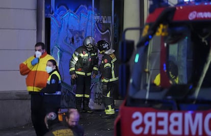 Fire crews outside the building on fire at Tetuán square in Barcelona.