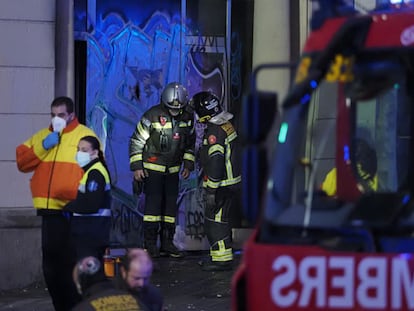 Fire crews outside the building on fire at Tetuán square in Barcelona.