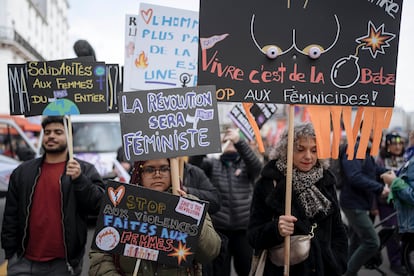 A woman holds a placard reading &#xab;Revolution will be feminist&#xbb; during a demonstration as part of the International Women's Day, Friday, March 8, 2024 in Paris. Marches, demonstrations and conferences are being held the world over, from Asia to Latin America and elsewhere to mark International Women's Day. (AP Photo/Lewis Joly)