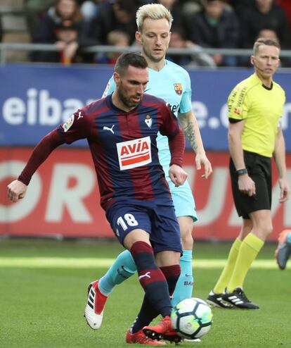 El defensa del Eibar, Anaitz Arbilla (i) con el balón seguido por el centrocampista suizo del Barcelona Ivan Rakitic.