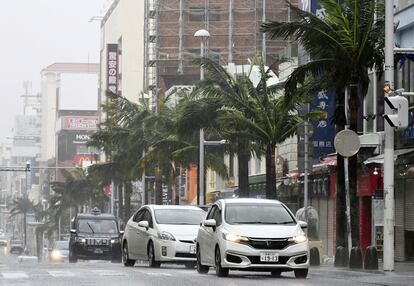 Vehicles drive through a street in a strong wind in Naha, Okinawa prefecture, southern Japan Sunday, Aug. 6, 2023