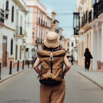 Young Asian woman with backpack finding direction while traveling. Travel and vacation. Lifestyle and technology.