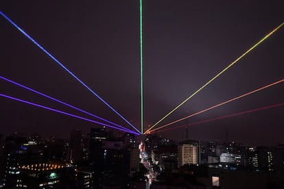 TOPSHOT - The Global Rainbow, a large scale outdoor laser projection created by Puerto Rican artist Yvette Mattern, is projected into the night sky to mark Gay Pride Parade Day, which was cancelled due to the COVID-19 novel coronavirus pandemic, in Sao Paulo, Brazil, on June 14, 2020. (Photo by Nelson ALMEIDA / AFP)