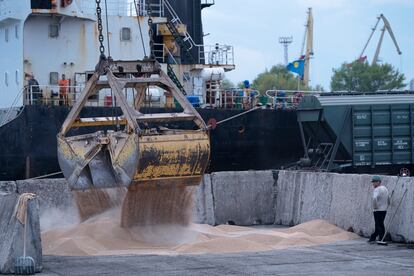 Workers load grain at a grain port in Izmail, Ukraine, Wednesday, April 26, 2023