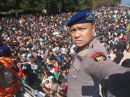 El Jefe de policía de Lombok, Dewa Wijaya, se toma una fotografía frente a los cientos de turistas tratando de abandonar las islas Gili tras el terremoto, el 6 de agosto de 2018. 