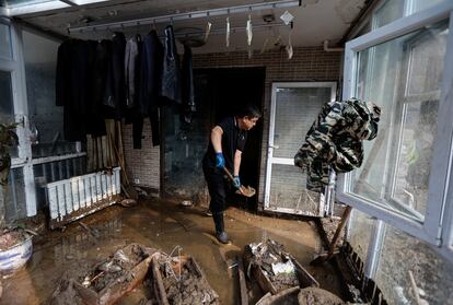 Las autoridades chinas advirtieron recientemente de un alto riesgo de inundaciones y tifones en agosto. En la imagen, un hombre limpia su vivienda dañada después de las lluvias provocadas por el tifón Doksuri, en el distrito de Mentougou de Pekín. 
