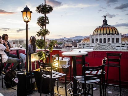 Terraza de un café en Ciudad de México, con el Palacio de Bellas Artes al fondo.