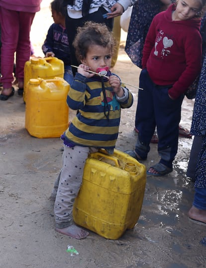 A child waits in a line to receive water, in Rafah, on January 28.