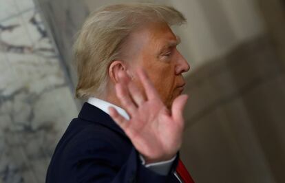Donald Trump gestures to the media during a short recess on the third day of his civil fraud trial in New York, October 4, 2023.