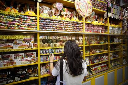 Reportaje sobre adicción al azúcar. Una chica ante una tienda de caramelos.