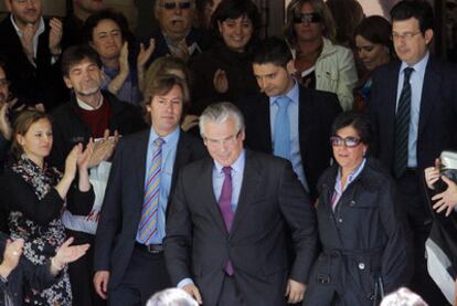 Garzón, junto a su esposa, baja las escaleras de la Audiencia rodeado de compañeros.