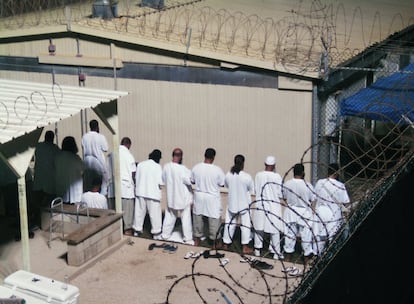 Los detenidos participan en una sesión de oración de la mañana en el campo 4