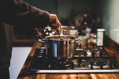 Un hombre prepara comida en una olla.