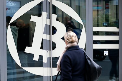 Una mujer, frente al banco La Maison du Bitcoin en 2017 en París.  (Photo by Chesnot/Getty Images)