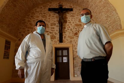 El sepulturero, Leandro Cañaveras, y el sacerdote, Alberto García, a la entrada del cementerio.