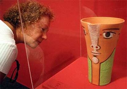 Una mujer observa la cerámica <i>Visage</i> (Rostro), de 1958, en la exposición de Jean Cocteau.