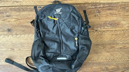 Mochila impermeable sobre mesa de madera.