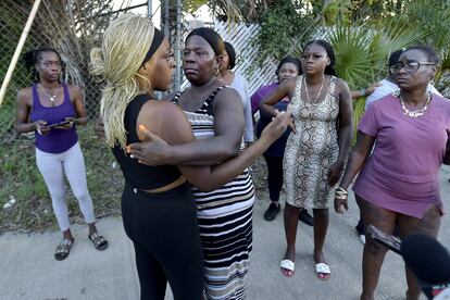 Neighborhood resident Virginia Bradford hugs a woman who came to the police line after going to the hospital to see her child and the child's father who she said were shot at the Dollar General Store in Jacksonville, Florida, U.S. August 26, 2023.