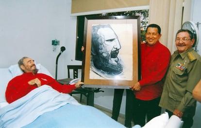El presidente de Venezuela Hugo Chavez (c) muestra un dibujo de Fidel Castro junto con el presidente en funciones Raúl Castro (d) días después de la operación quirúrgica de Fidel Castro (i) en La Habana (Cuba).