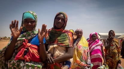 Women who have been forcibly displaced from West Darfur wait to receive food packages, in a refugee camp in Adre, in Chad, on the border with Sudan, on April 12, 2024.