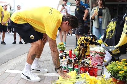 An AEK Athens club soccer player places flowers outside Agia Sophia Stadium, the home stadium of AEK Athens soccer team following clashes between soccer fans, on August 8, 2023.