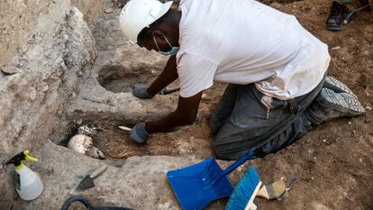 Un operario rescata los restos humanos hallados a los pies de la muralla árabe de Valencia.