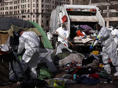 Members of a clean-up crew remove belongings that have been left behind by occupants as the National Park Service clears the homeless encampment at McPherson Square on February 15, 2023 in Washington, DC.