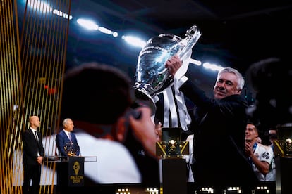 Jordi Cruyff and Hristo Stoichkov represent Real Madrid coach Carlo Ancelotti after receiving the award for the best men's coach of the year.