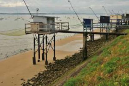 Palafitos o pêcheries al pie del paseo marítimo de la playa de Saint-Nazaire.