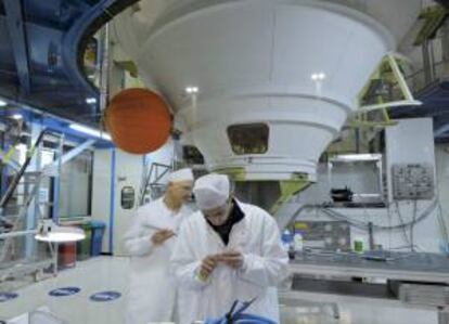 Dos técnicos trabajan sobre el primer motor del cohete Ariane-5 en la sede de Astrium en Les Mureaux, Francia. EFE/Archivo